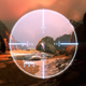 A first-person view shows a Halo character laying their crosshairs on a distant figure.